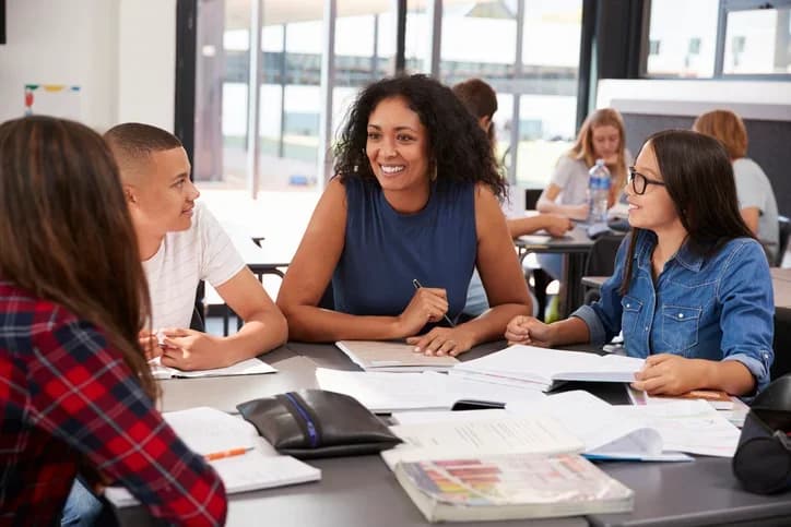 Teacher and students in a classroom discussion